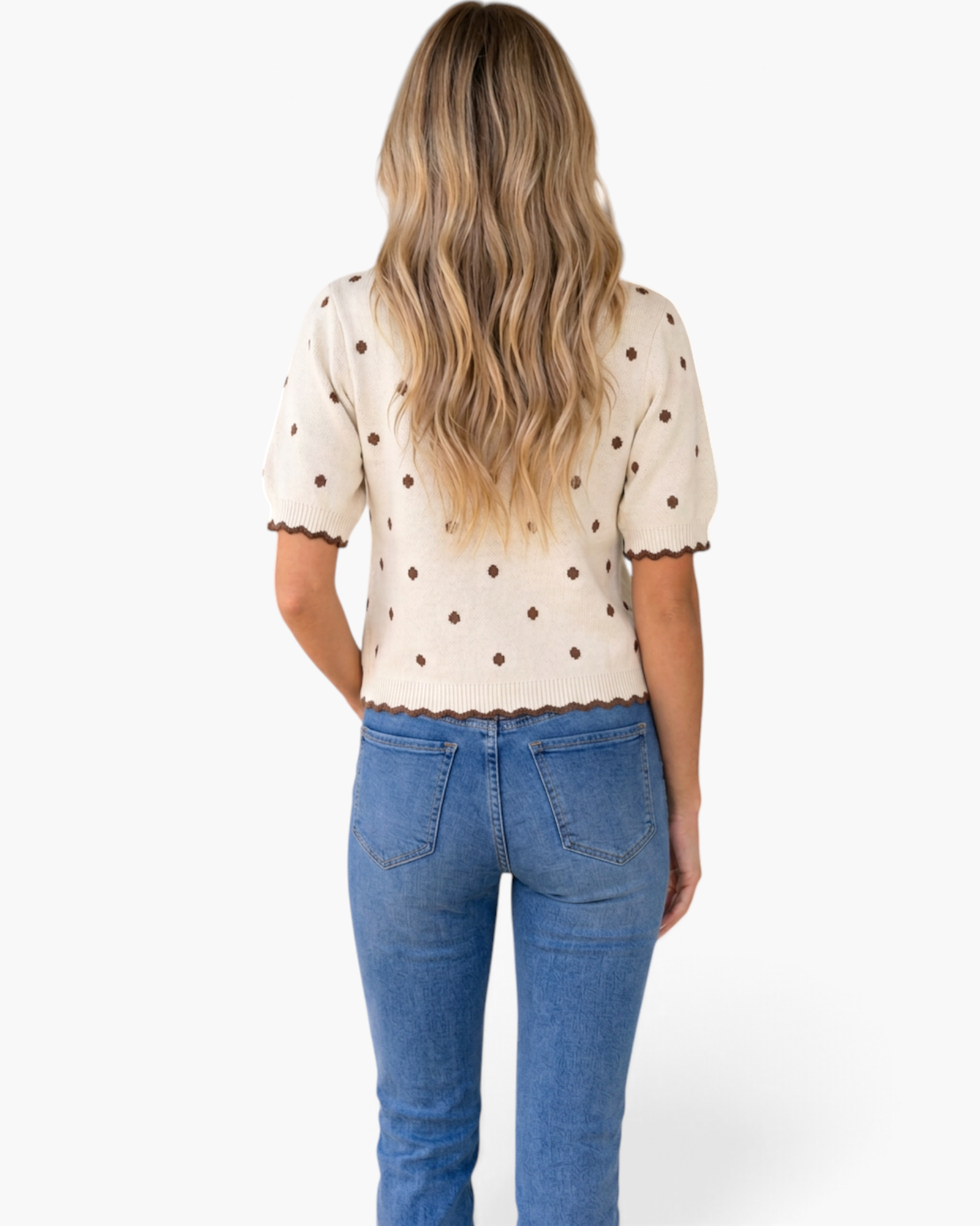 Back view of a Beach Rose Co. ivory cotton knit top with brown polka dots, puff sleeves, and scalloped trim.