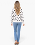 Beach Rose Co. ivory sweatshirt with black polka dots, dropped shoulders, and long sleeves, worn with blue jeans.
