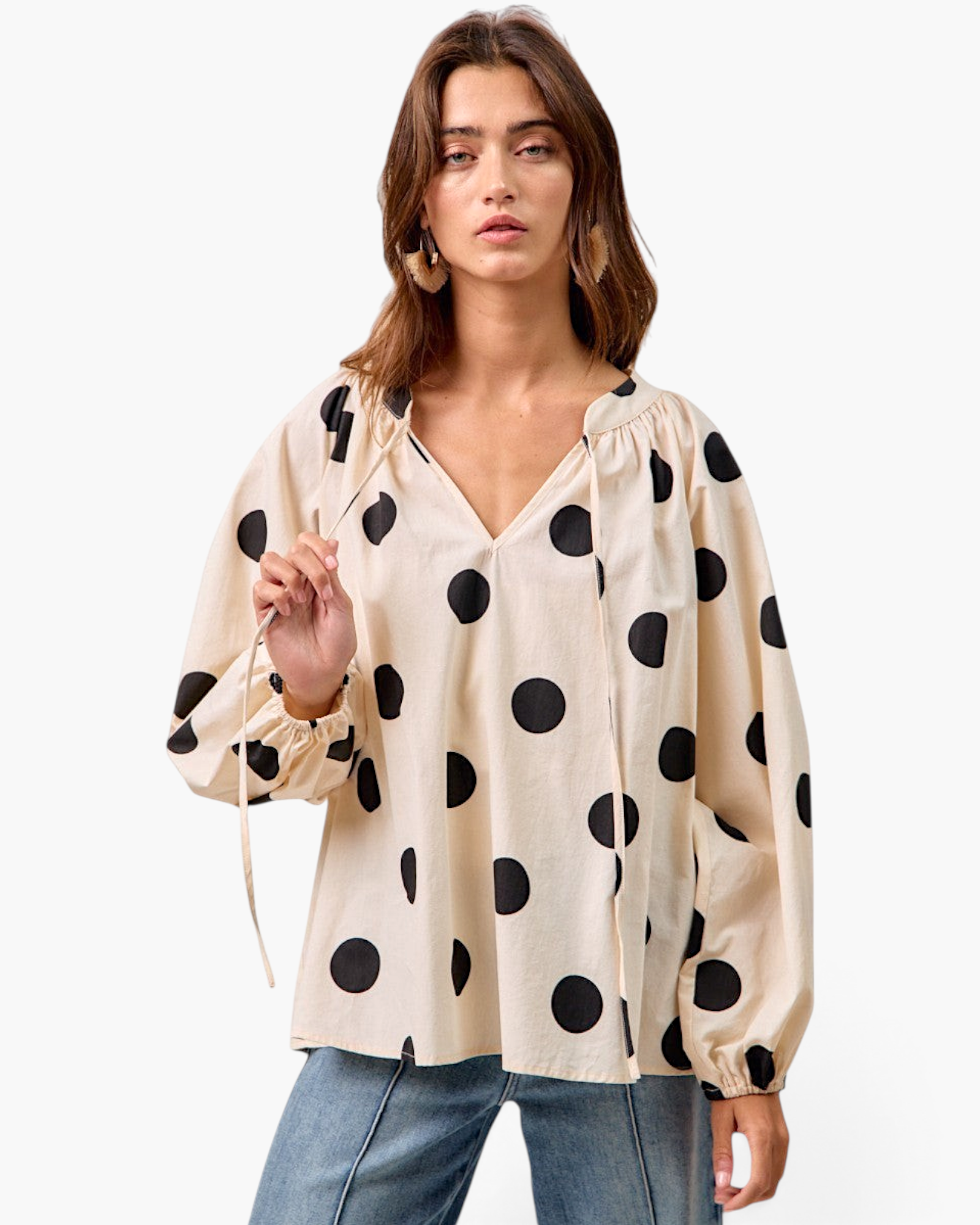 Beach Rose Co. ivory cotton top with black polka dots, long balloon sleeves, and a tie-neck detail on a model.
