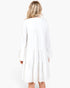 Back view of Beach Rose Co. ivory tiered shift dress with long bell sleeves and gathered detailing on white background