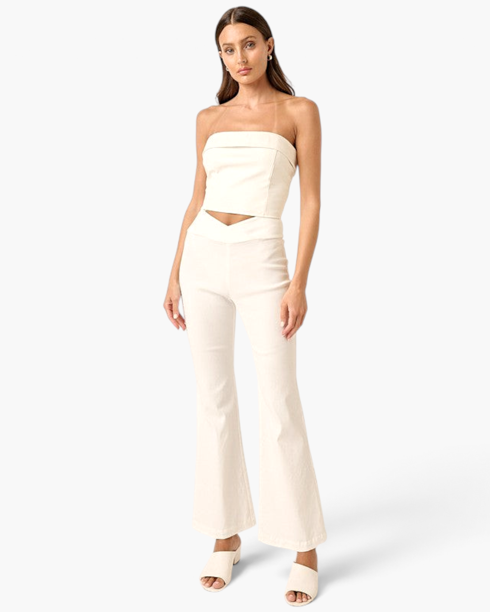 Beach Rose Co. ivory high-rise flare pants with a crossover V-waist, worn by a model with a matching strapless top.