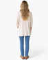 Beach Rose Co. ivory waffle-knit tunic top with three-quarter sleeves and high-low hem worn with blue jeans