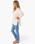 Beach Rose Co. ivory waffle-knit V-neck tunic top with three-quarter sleeves and side slits worn with blue jeans