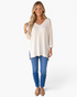 Beach Rose Co. ivory waffle-knit V-neck tunic top with three-quarter sleeves worn by a smiling blonde model
