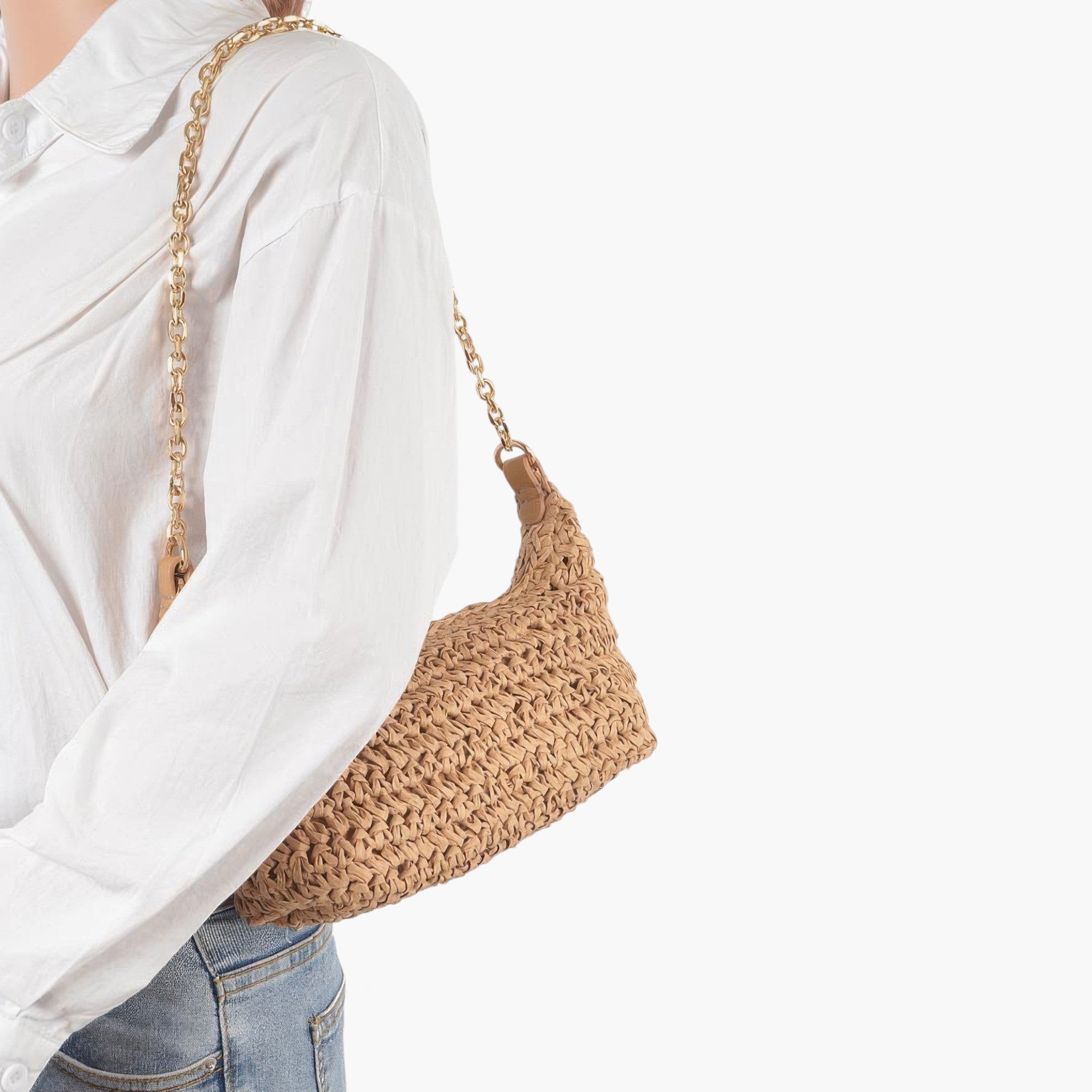 Beach Rose Co. khaki faux straw shoulder clutch with a gold chain strap worn over the shoulder