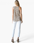 Beach Rose Co. khaki tank top with black spotted print, sleeveless relaxed fit worn with white jeans, back view