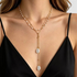 Beach Rose Co. 18K gold-plated layered Y-necklace with white faux pearl drops and gold bead accents on a model