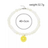 Beach Rose Co. white resin beaded necklace featuring a yellow lemon slice pendant with an adjustable lobster clasp.