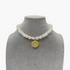 Beach Rose Co. white resin beaded necklace featuring a yellow lemon slice pendant on a grey jewelry display bust.