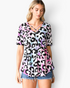 Beach Rose Co. multicolor leopard print babydoll top with a crisscross V-neckline and short sleeves on a model