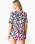Beach Rose Co. multicolor leopard print babydoll top with short sleeves and a relaxed fit worn by a model