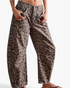 Beach Rose Co. relaxed barrel leg jeans in a brown leopard print cotton blend with knee darts and curved seams.