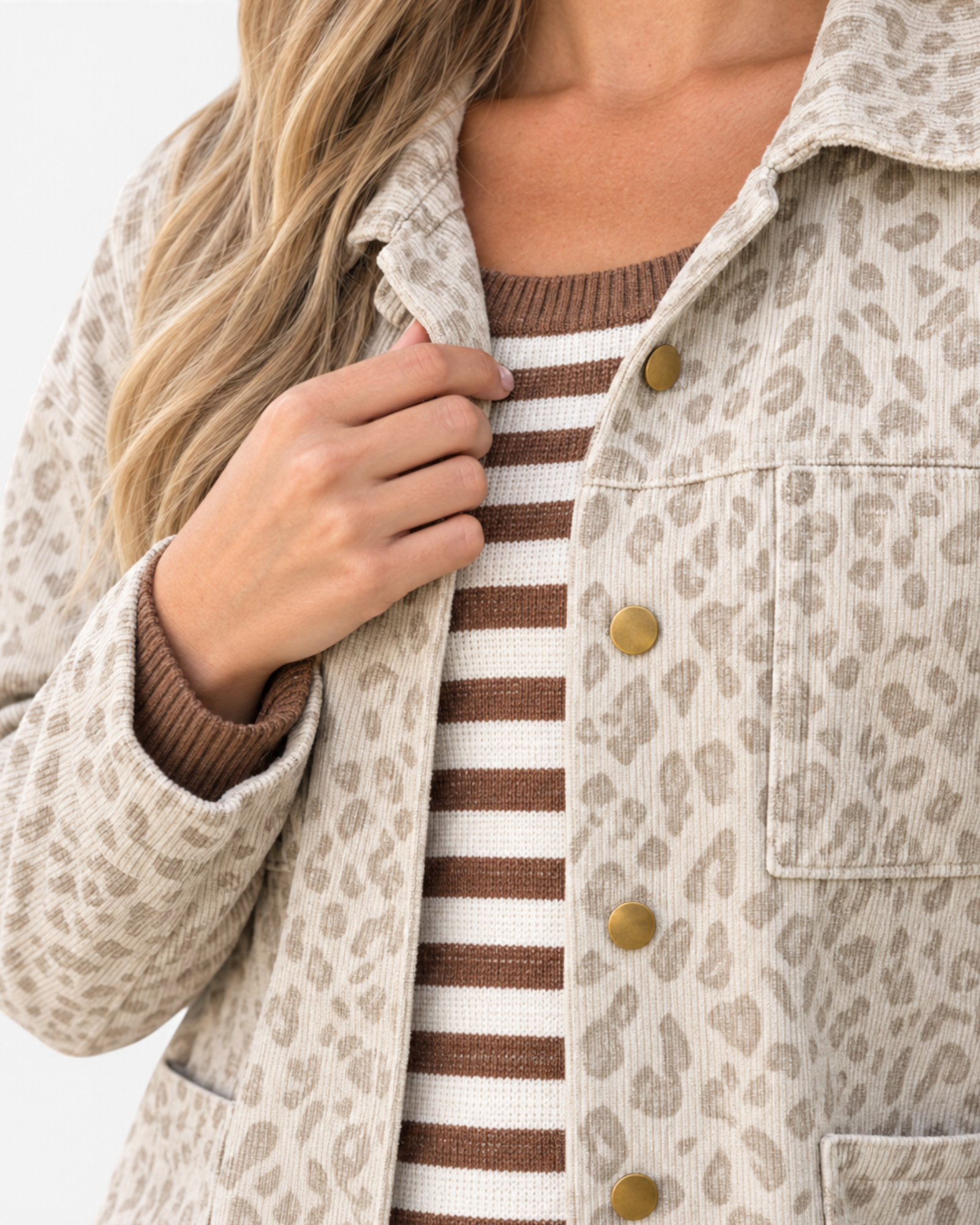 Beach Rose Co. cream and taupe leopard print corduroy shacket with gold-tone buttons worn over a striped knit top
