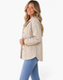 Beach Rose Co. cream and taupe leopard print corduroy shacket with gold buttons worn by a smiling blonde model