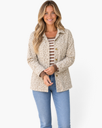 Beach Rose Co. cream and taupe leopard print corduroy shacket with gold buttons worn by a smiling blonde model.