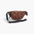 Beach Rose Co. leopard print faux suede sling bag with an adjustable black strap and double zip-top closure.