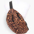 Beach Rose Co. leopard print faux suede sling bag with a double zip closure and adjustable black strap on a mannequin