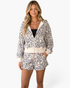 Beach Rose Co. leopard print hooded zip-up jacket and drawstring shorts set worn by a blonde model.