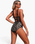 Beach Rose Co. leopard print one-piece swimsuit with sheer mesh panels, ring straps, and a lace-up back detail.