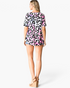 Beach Rose Co. multicolor leopard print babydoll top with short sleeves and curved hem worn by a blonde model