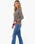 Beach Rose Co. long sleeve leopard print top with red trim on a blonde model wearing blue jeans