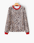 Beach Rose Co. long sleeve top in tan and black leopard print with contrasting red crew neckline and sleeve cuffs.