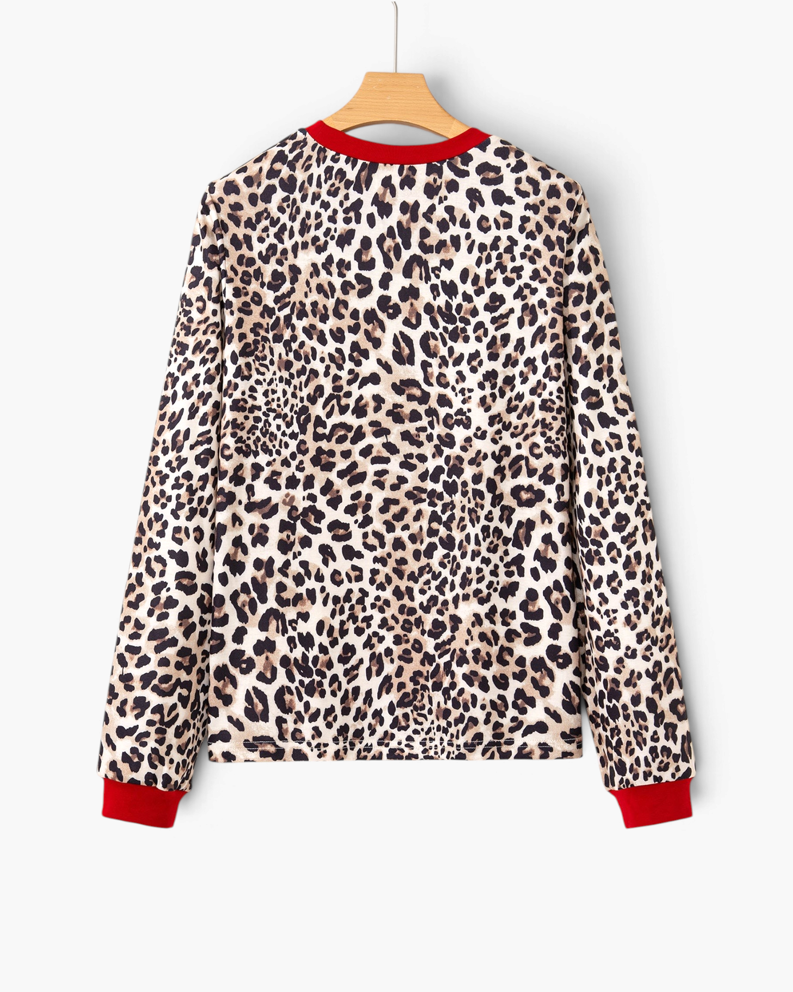 Beach Rose Co. long sleeve top in tan and black leopard print with contrasting red crew neckline and sleeve cuffs.