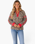 Beach Rose Co. cream leopard print sherpa pullover with a half-zip stand collar and bold red trim on sleeves