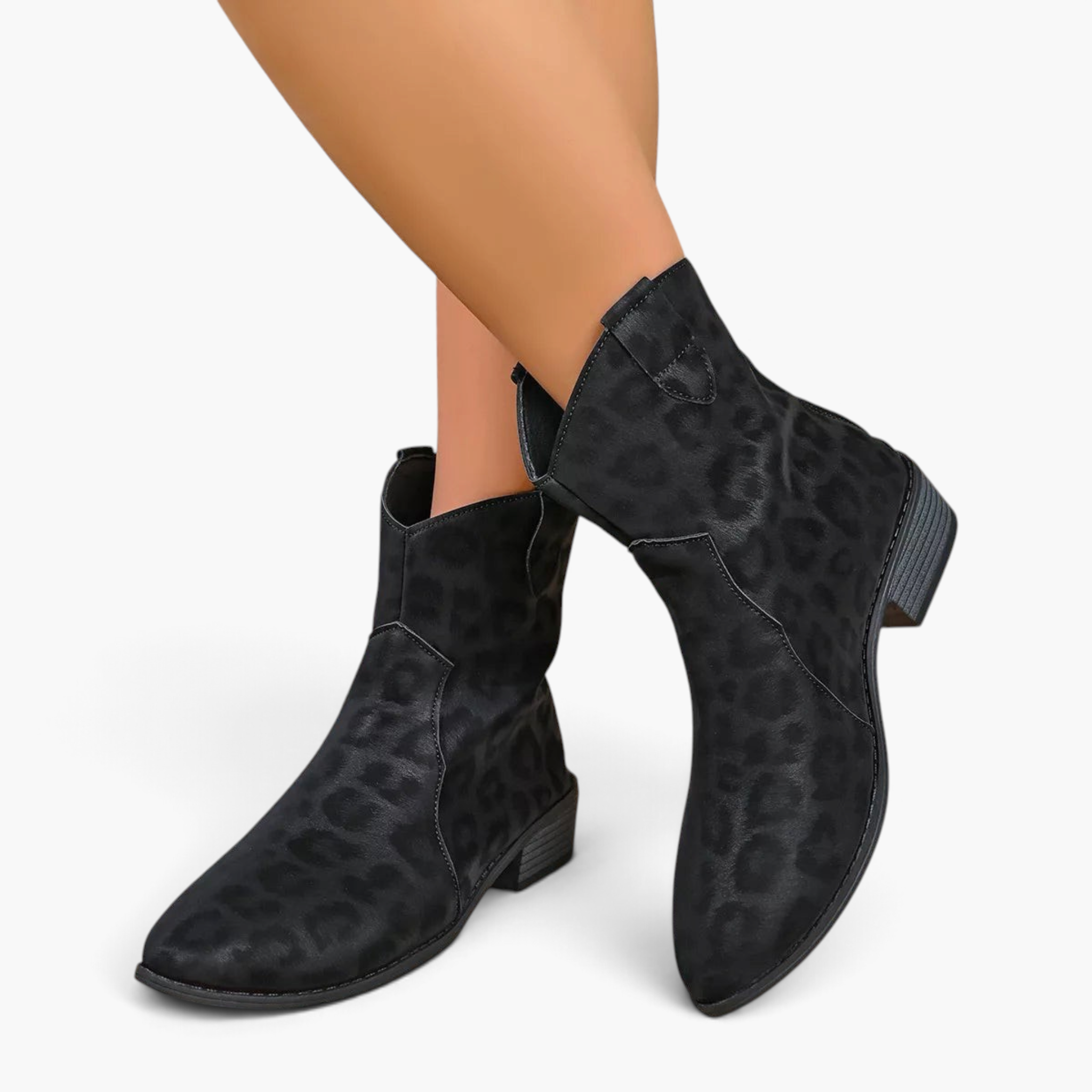 Beach Rose Co. black suede western ankle boots with leopard print, curved shaft, and low block heel on a model.