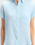 Beach Rose Co. light blue cotton button-up top with rolled sleeves and a single chest pocket on a model
