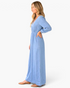 Beach Rose Co. light blue cotton maxi dress with puff sleeves and gathered waist, shown from a side profile view.