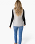 Beach Rose Co. light gray quilted vest with a faux-fur collar worn by a woman with long blonde hair, back view