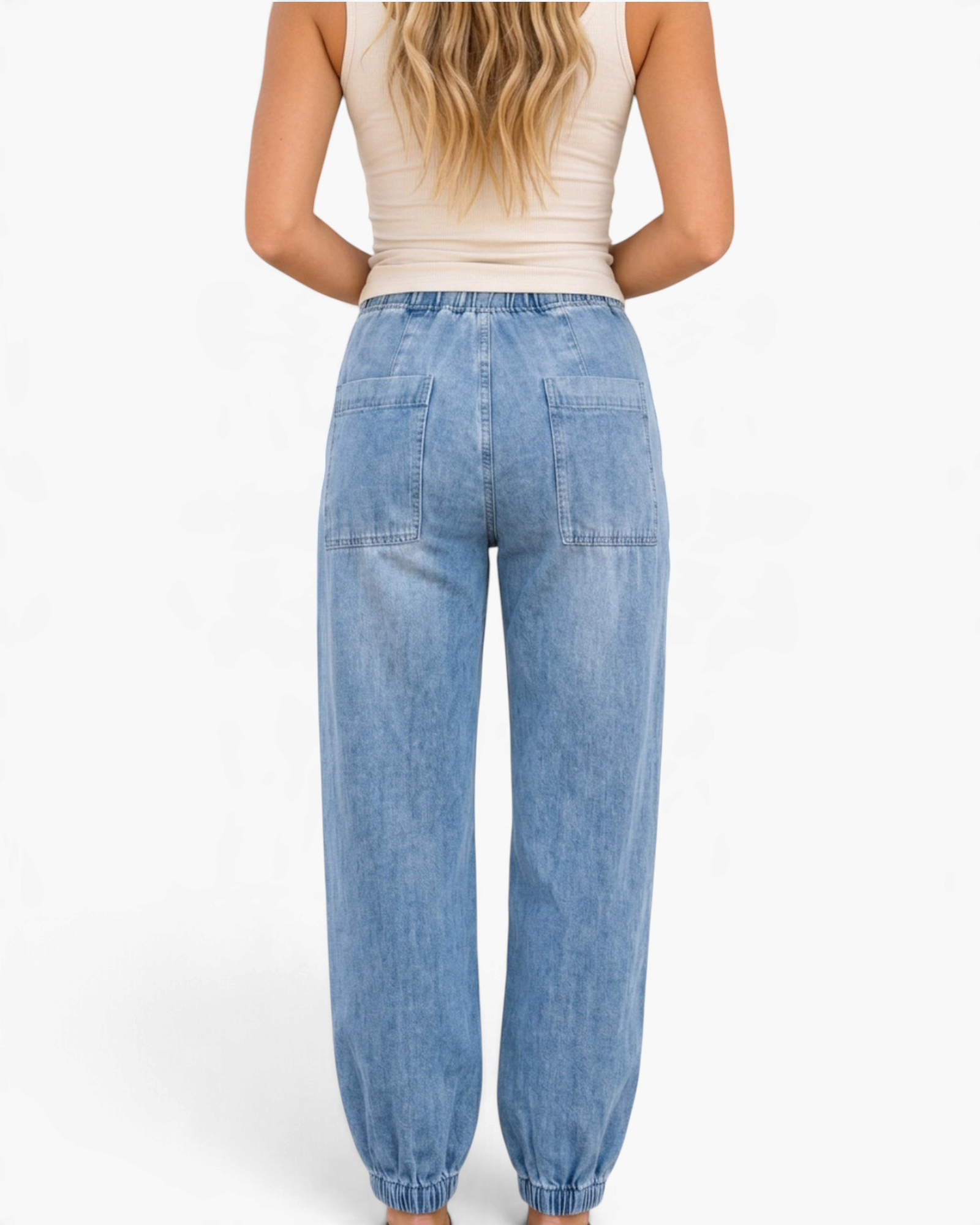Beach Rose Co. light wash denim joggers with back patch pockets, elastic drawstring waist, and gathered ankle cuffs.