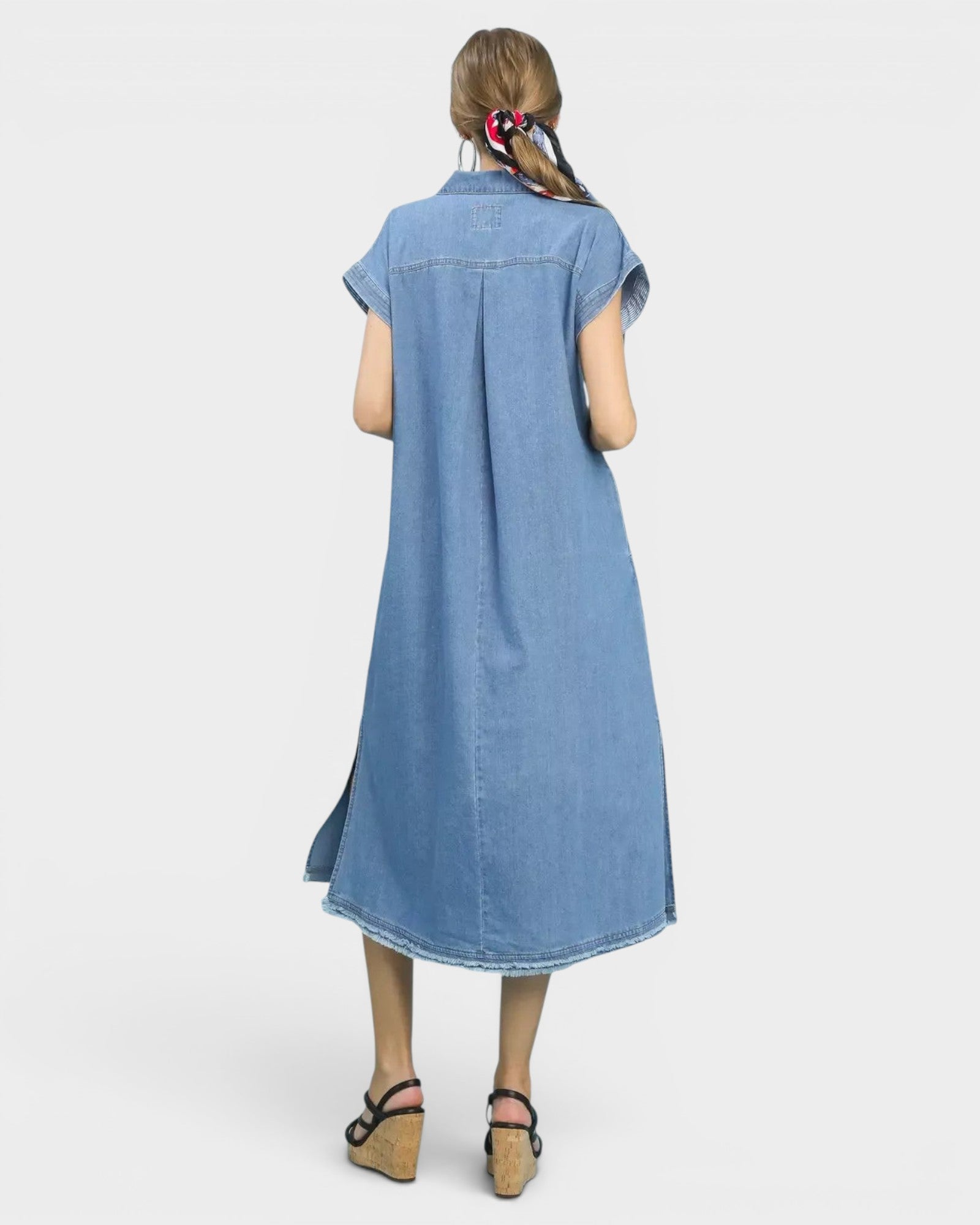 Beach Rose Co. light wash denim midi dress with collared neckline, short sleeves, side pockets, and frayed hem.