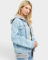 Beach Rose Co. light wash denim jacket with gray hood and ribbed hem, zip front, chest pockets, and relaxed fit.