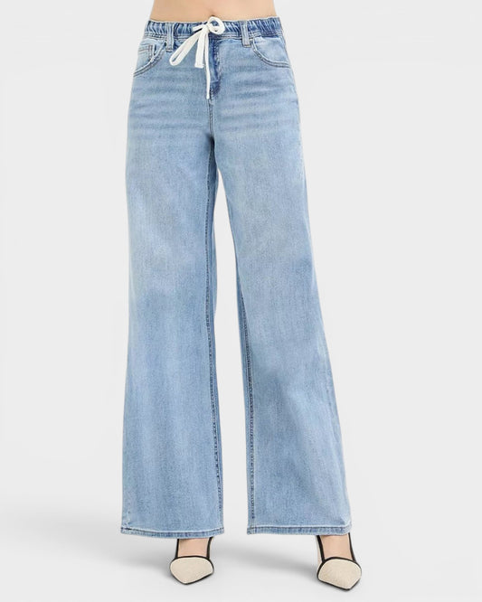 Beach Rose Co. light wash denim wide leg jeans with drawstring waist and pockets. Relaxed fit, casual street style.