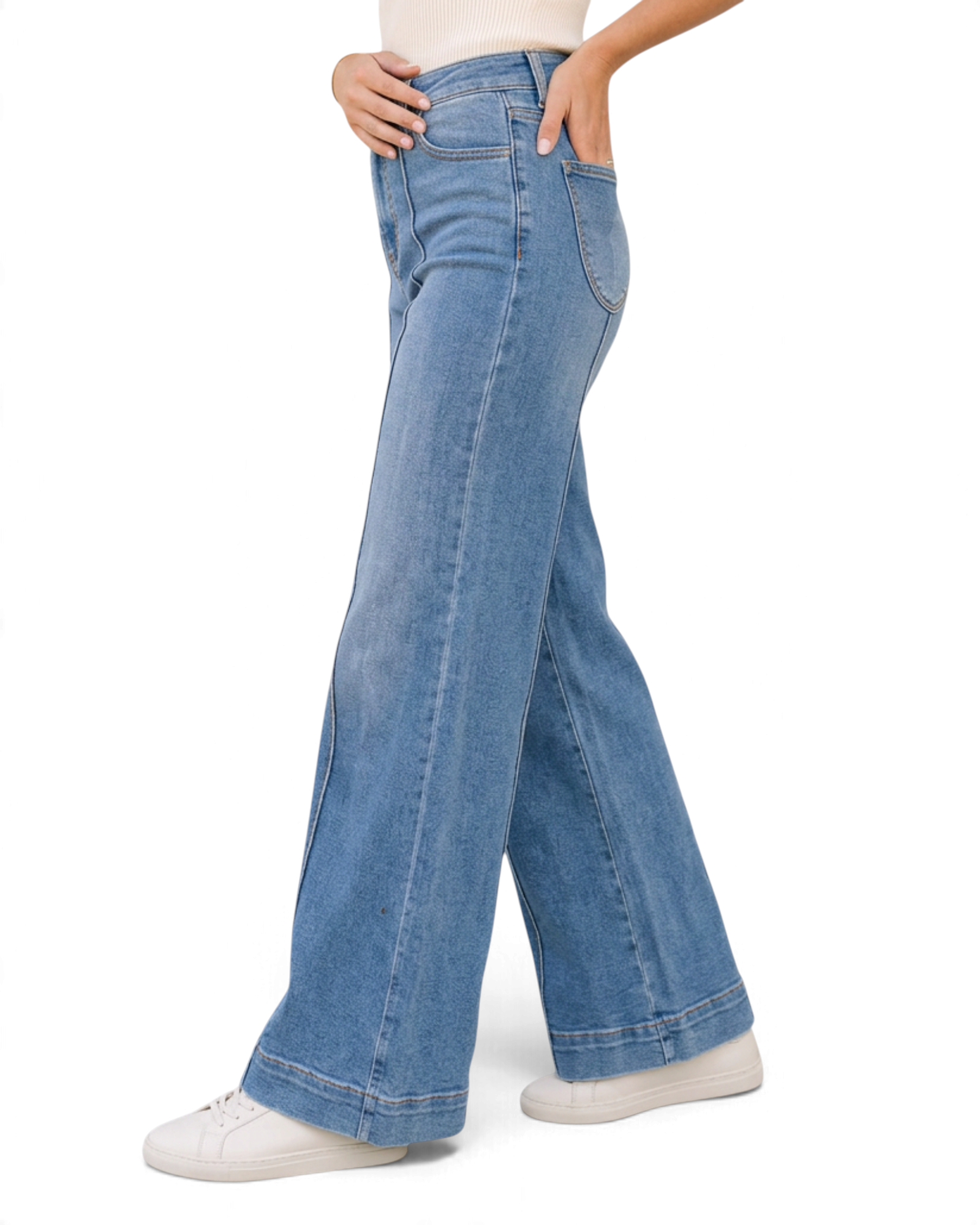 Beach Rose Co. light wash wide leg jeans with vertical seam details and deep stitched hems worn with white sneakers