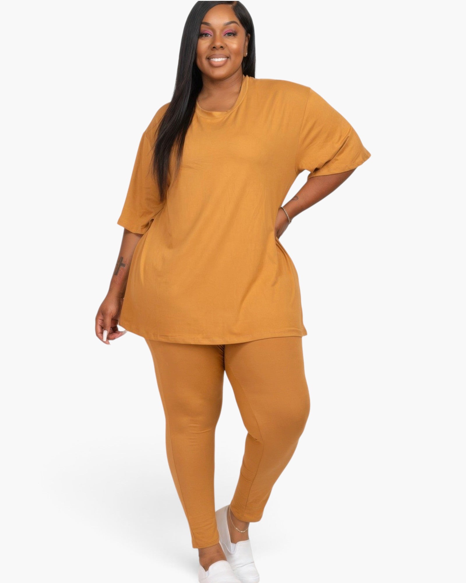 Beach Rose Co. plus size model wearing a mango-colored oversized t-shirt and matching leggings lounge set.