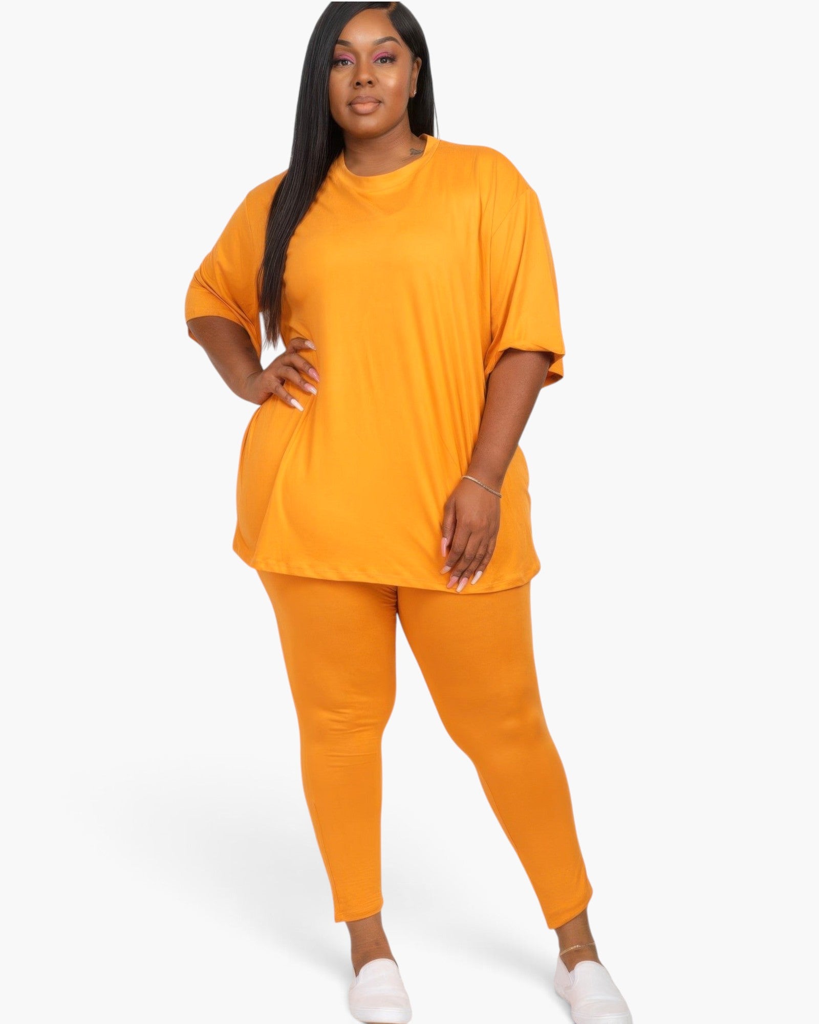 Beach Rose Co. plus size mango orange oversized t-shirt and leggings set worn by a model with long dark hair.