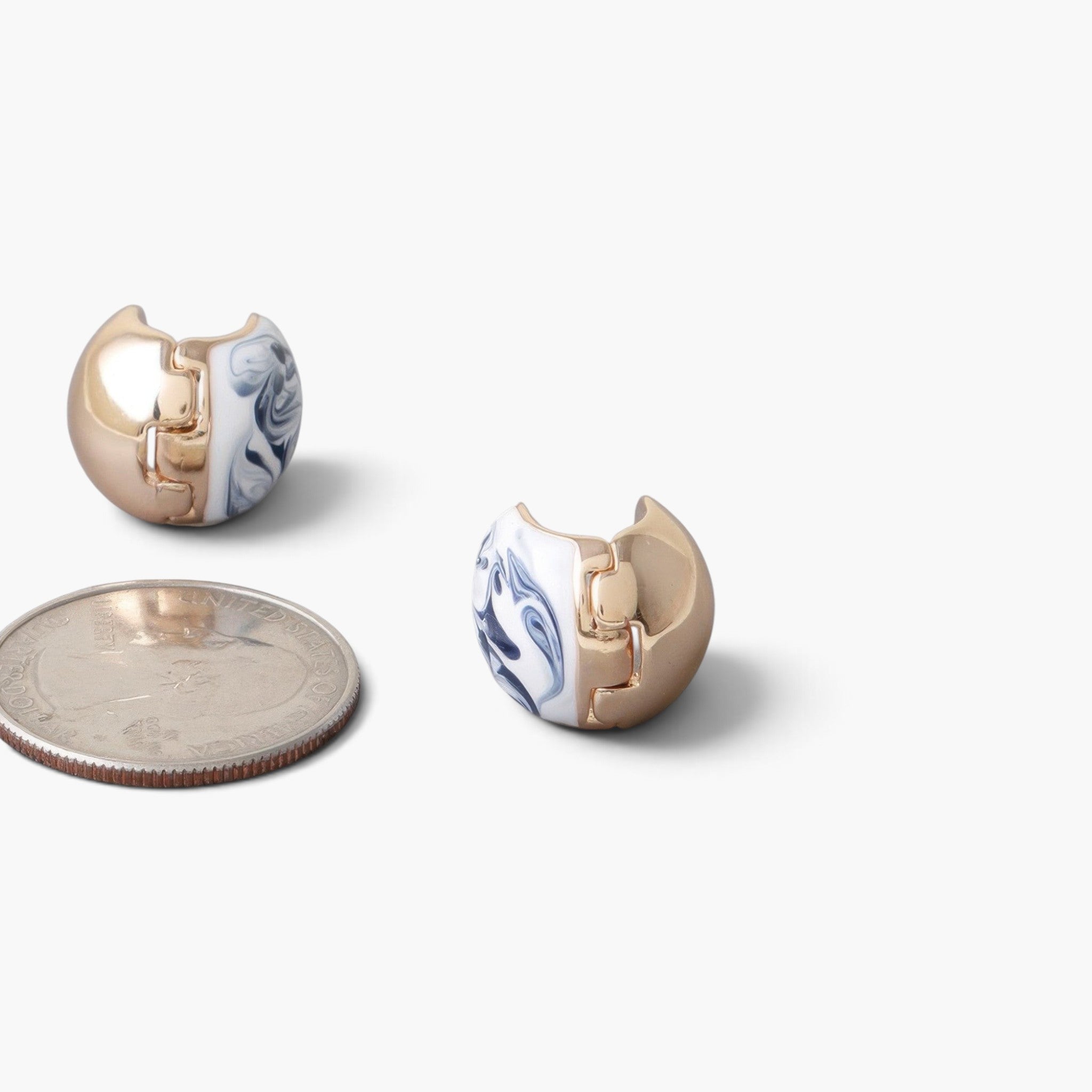 Beach Rose Co. vintage gold-plated clasp earrings featuring a blue and white marble swirl design next to a US quarter.
