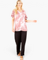 Beach Rose Co. mauve tie-dye V-neck top with layered ruffle sleeves worn by a blonde model with black trousers