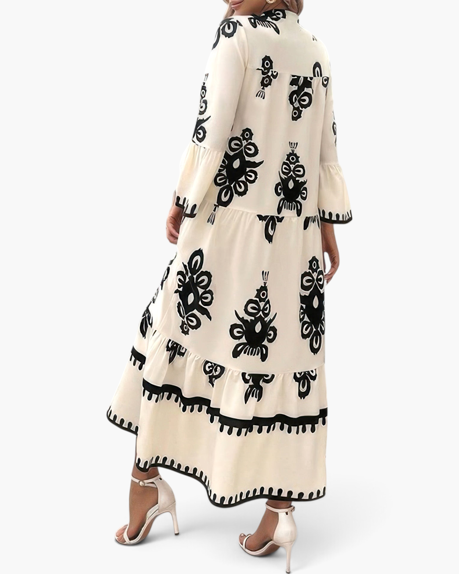 Beach Rose Co. cream maxi dress with black medallion print, tiered silhouette, and bell sleeves, back view.
