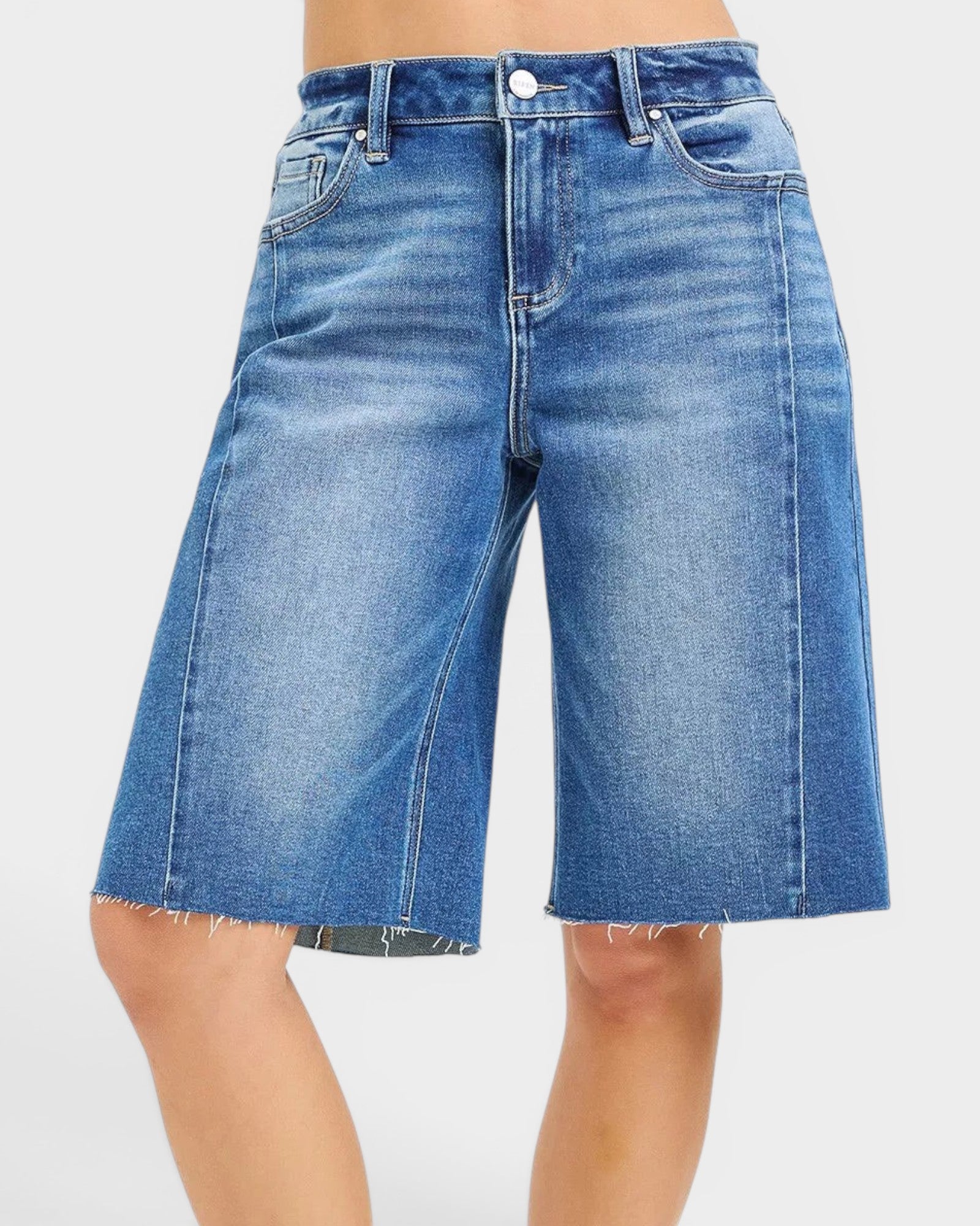 Beach Rose Co. medium wash denim Bermuda shorts with raw hem, five-pocket styling, and stretch fabric.