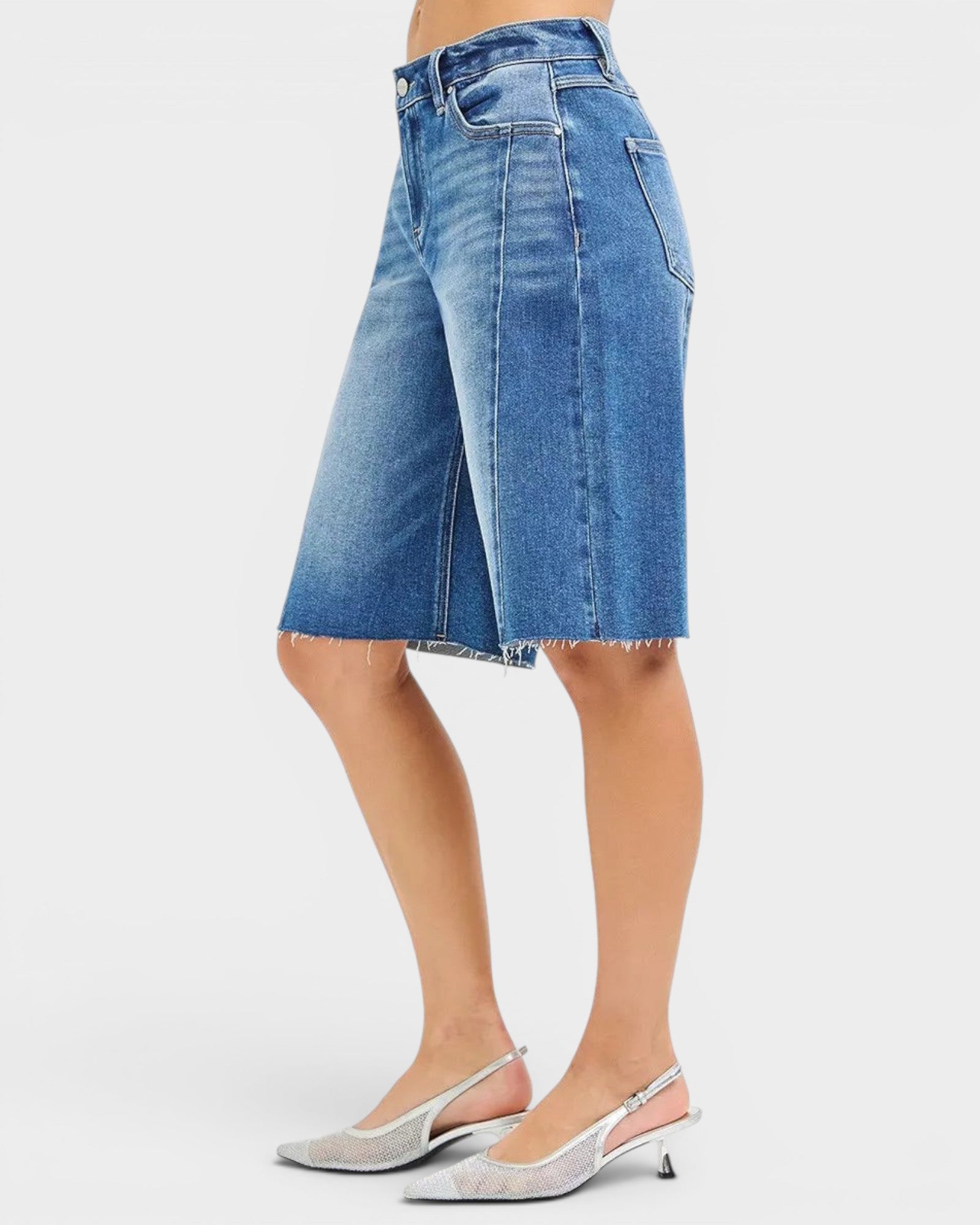Beach Rose Co. medium wash denim Bermuda shorts with raw hem and five-pocket styling.