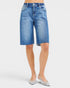 Beach Rose Co. medium wash denim Bermuda shorts with raw hem, five-pocket styling, and stretch fabric.