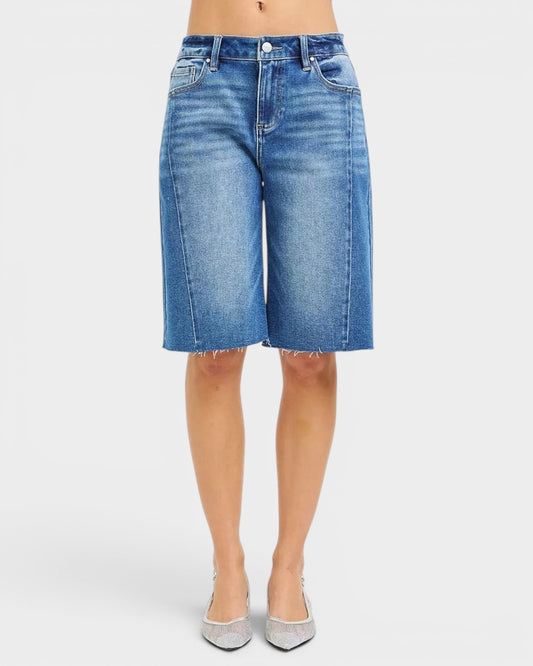 Beach Rose Co. medium wash denim Bermuda shorts with raw hem, five-pocket styling, and stretch fabric.