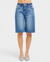 Beach Rose Co. medium wash denim Bermuda shorts with raw hem, five-pocket styling, and stretch fabric.