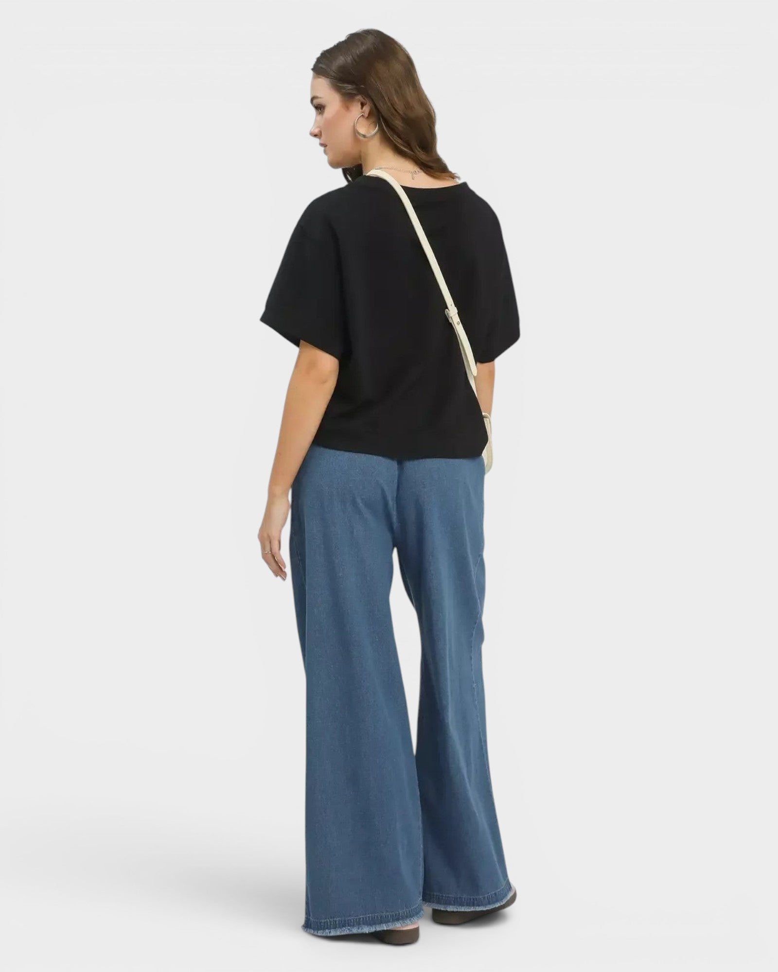 Beach Rose Co. medium wash 100% cotton wide leg jeans with raw hem and elastic waist.