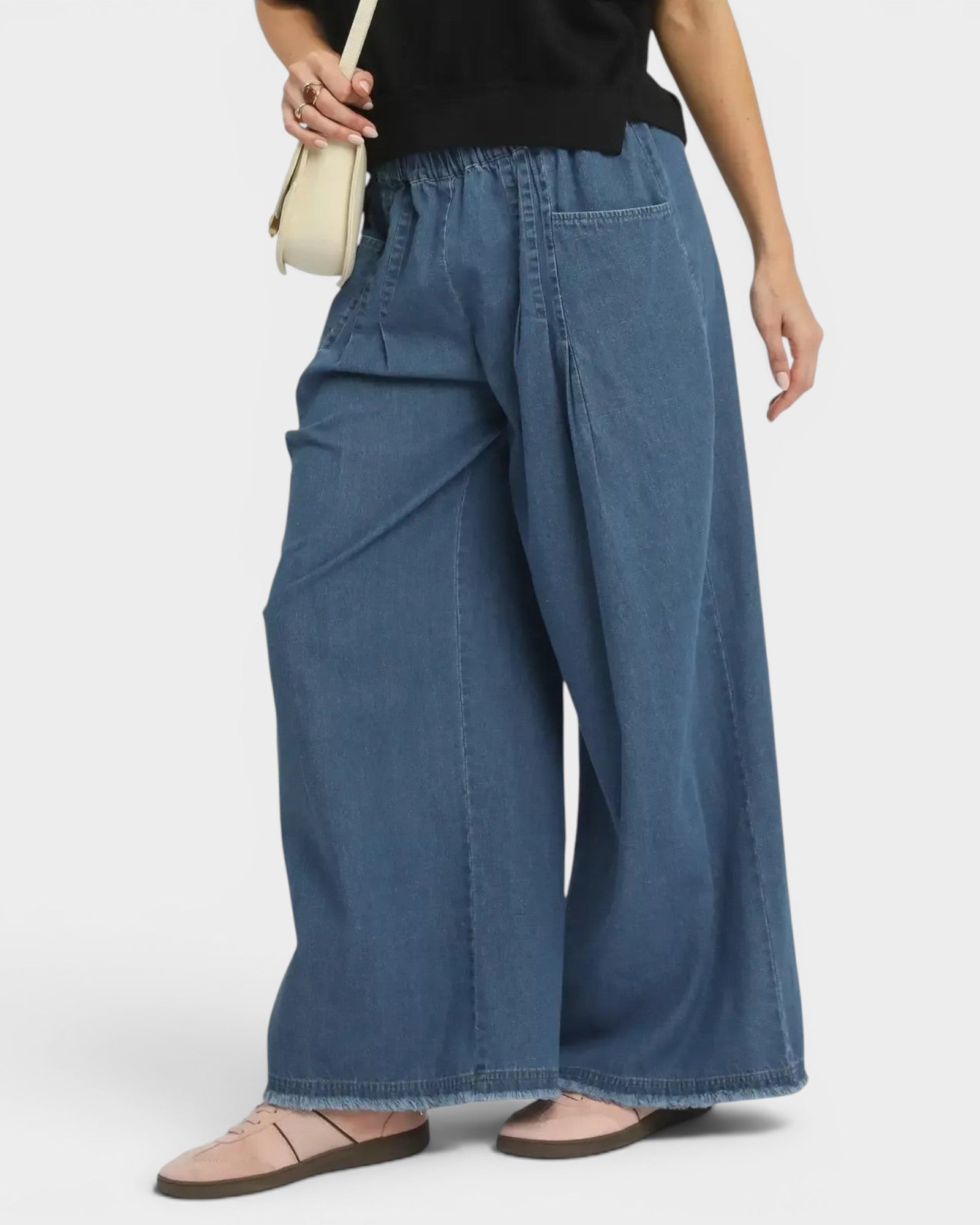 Beach Rose Co. medium wash denim wide leg jeans with elastic waist, raw hem, and pockets. Relaxed fit, 100% cotton.