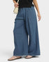Beach Rose Co. medium wash denim wide leg jeans with elastic waist, raw hem, and pockets. Relaxed fit, 100% cotton.